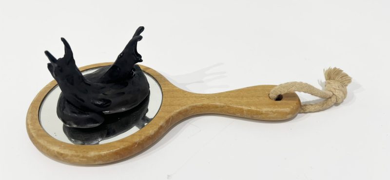 Tai Snaith 'Flotilla (there’s no dignity in haste) 23' 2025 glazed black midfire ceramic and vintage mirror 20 x 11 x 7 cm $330