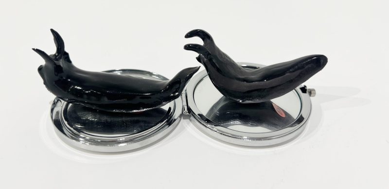 Tai Snaith 'Flotilla (there’s no dignity in haste) 27' 2025 glazed black midfire ceramic and vintage mirror 15 x 8 x 4.5 cm $220